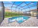 Beautiful screened-in pool with brick pavers and lush landscaping offers a private outdoor oasis at 13543 Abberwick Dr, Orlando, FL 32832