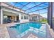 Inviting screened-in pool surrounded by brick pavers and manicured landscaping for a resort-style experience at 13543 Abberwick Dr, Orlando, FL 32832