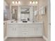 Bathroom with double sinks and a clear view to the bedroom at 1449 Fairview Cir, Reunion, FL 34747