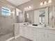 Bathroom featuring a double sink vanity and shower at 1449 Fairview Cir, Reunion, FL 34747