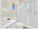 Bright bathroom featuring a glass enclosed shower, toilet, and vanity with sink and plush towels at 1449 Fairview Cir, Reunion, FL 34747