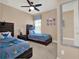 Charming bedroom with two twin beds, themed bedding and decor, and a ceiling fan for comfort at 1449 Fairview Cir, Reunion, FL 34747