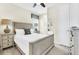 Comfortable bedroom with a queen bed and bedside tables with lamps and a ceiling fan for optimal air circulation at 1449 Fairview Cir, Reunion, FL 34747