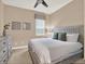 Comfortable bedroom with a ceiling fan, soft lighting, and carpet flooring at 1449 Fairview Cir, Reunion, FL 34747