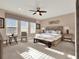 Bright bedroom featuring a king bed, ceiling fan, and bench seating at 1449 Fairview Cir, Reunion, FL 34747