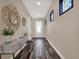 Inviting entryway features stylish decor, a console table, and a sunlit door to welcome guests at 1449 Fairview Cir, Reunion, FL 34747