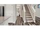 Hallway showcasing hardwood floors and a staircase to the second floor at 1449 Fairview Cir, Reunion, FL 34747