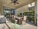 The covered patio offers a dining area, fan and an outdoor view at 1449 Fairview Cir, Reunion, FL 34747