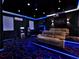 The theater room is fully furnished with a gaming area, seating and ambient lighting at 1449 Fairview Cir, Reunion, FL 34747