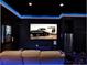 Entertaining theater room with blue lighting, large screen, and comfortable seating for hours of enjoyment at 1449 Fairview Cir, Reunion, FL 34747