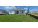 A well-manicured lawn complements the home's back exterior with its covered lanai, creating a peaceful outdoor space at 14599 Crestavista Dr, Clermont, FL 34714