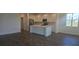 Expansive living space showcasing hardwood floors, an open layout, abundant natural light, and kitchen access at 14599 Crestavista Dr, Clermont, FL 34714
