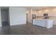 Open-concept living area with hardwood floors, access to kitchen, and great natural light at 14599 Crestavista Dr, Clermont, FL 34714