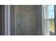 Modern shower featuring a glass enclosure, a rain shower head, and sleek, tiled walls at 14599 Crestavista Dr, Clermont, FL 34714