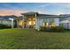 Well-maintained backyard with a spacious lawn, a modern home exterior and serene surroundings at 14749 Walcott Ave, Orlando, FL 32827