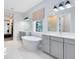 Bright bathroom with a modern soaking tub, double vanities, and walk-in closet access at 14749 Walcott Ave, Orlando, FL 32827