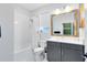 Clean, modern bathroom with white tile and gray vanity at 14749 Walcott Ave, Orlando, FL 32827