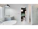 Luxurious bathroom featuring a standalone tub, tiled shower, and access to a bedroom at 14749 Walcott Ave, Orlando, FL 32827