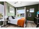 Bright bedroom with green walls, natural light, and stylish decor at 14749 Walcott Ave, Orlando, FL 32827
