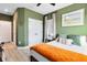 Stylish bedroom with warm green walls and minimalist furniture at 14749 Walcott Ave, Orlando, FL 32827