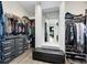 Spacious walk-in closet with custom shelving, drawers, and seating for optimal organization and style at 14749 Walcott Ave, Orlando, FL 32827