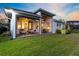 Inviting covered patio with ceiling fans and comfortable seating, ideal for outdoor dining and relaxation overlooking the lawn at 14749 Walcott Ave, Orlando, FL 32827