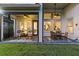 Stylish covered patio featuring a dining table and Adirondack chairs, overlooking the landscaped lawn and backyard at 14749 Walcott Ave, Orlando, FL 32827