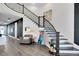 Grand foyer with curved staircase, elegant decor, and modern lighting creating a welcoming ambiance at 14749 Walcott Ave, Orlando, FL 32827