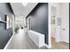 Elegant hallway featuring dark accent walls, sleek white storage, and bright, airy lighting at 14749 Walcott Ave, Orlando, FL 32827