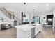 Spacious kitchen with a white island, modern pendant lights, and stainless steel dishwasher at 14749 Walcott Ave, Orlando, FL 32827