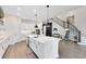 Bright, open kitchen featuring a large island, stainless steel appliances, and modern pendant lighting at 14749 Walcott Ave, Orlando, FL 32827