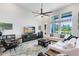 Bright living room with high ceilings, large windows, and comfortable seating arrangement at 14749 Walcott Ave, Orlando, FL 32827