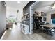 Open-concept living space with hallway leading to a bright office, kitchen, and dining area at 14749 Walcott Ave, Orlando, FL 32827