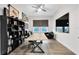 Bright home office with large desk, shelving, and comfortable seating area with backyard view at 14749 Walcott Ave, Orlando, FL 32827