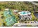 Aerial view showcasing community amenities including tennis courts and pool area with the clubhouse at 14751 Clarkson Dr, Orlando, FL 32828