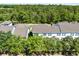 Aerial view of townhouse community with mature trees and landscaping offers a serene setting at 14751 Clarkson Dr, Orlando, FL 32828