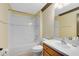 Bathroom showing white tile, shower and tub, vanity and neutral paint at 14751 Clarkson Dr, Orlando, FL 32828