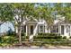 Home exterior features a well-manicured lawn, lush landscaping and a covered front entrance at 14751 Clarkson Dr, Orlando, FL 32828