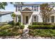 Charming two-story home with a well-manicured lawn and garden beds offers an inviting entrance at 14751 Clarkson Dr, Orlando, FL 32828