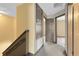 Bright hallway with neutral walls and carpet, complemented by dark trim and multiple doorways at 14751 Clarkson Dr, Orlando, FL 32828