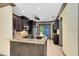 This elegant kitchen featuring dark wood cabinets, granite countertops, and stainless steel appliances is ready for entertaining at 14751 Clarkson Dr, Orlando, FL 32828