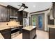 Modern kitchen featuring a central island, stainless steel appliances, and easy access to outdoor spaces through glass doors at 14751 Clarkson Dr, Orlando, FL 32828
