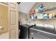 Laundry room comes equipped with modern washer/dryer units and ample shelving for storage at 14751 Clarkson Dr, Orlando, FL 32828
