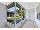 Screened patio with tile flooring, ceiling fan, and view of the exterior yard at 14751 Clarkson Dr, Orlando, FL 32828