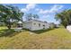 Spacious backyard with green grass, partial fencing and a view of the back of the home at 1620 Haddock St, St Cloud, FL 34771
