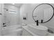 Updated bathroom with a tub, sleek fixtures, stylish vanity, and a modern aesthetic at 1620 Haddock St, St Cloud, FL 34771