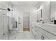 Modern bathroom with double sinks, sleek fixtures, frameless glass shower, and a walk-in closet at 1620 Haddock St, St Cloud, FL 34771