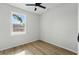 Bright bedroom featuring wood-style flooring and a large, sunlit window at 1620 Haddock St, St Cloud, FL 34771