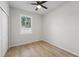 This bedroom offers ample natural light, a ceiling fan, and wood-style flooring at 1620 Haddock St, St Cloud, FL 34771
