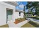 Exterior view of a home featuring a light-green front door and landscaped walkway at 1620 Haddock St, St Cloud, FL 34771